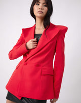 the model hold her hand to her chest while wearing the Quinn Red Double Breasted Blazer buttoned up