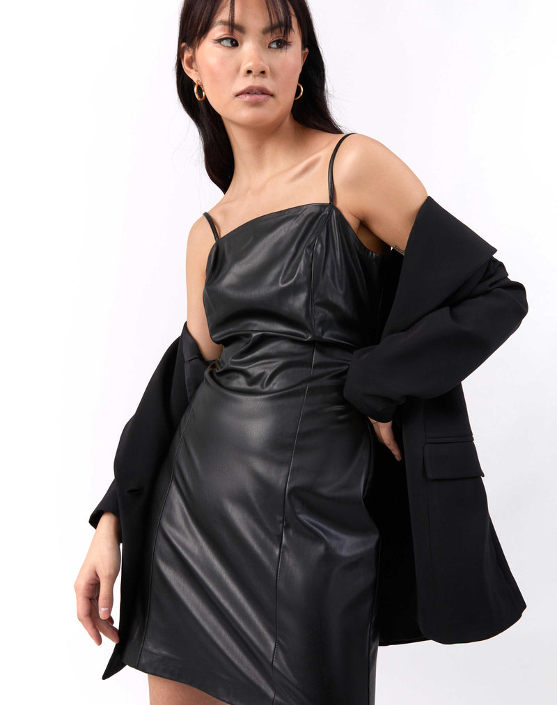 model shrugs blazer off her shoulders wearing the Ray Faux Leather Mini Dress in Black