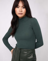 model wears the lorna green turtleneck ribbed knit bodysuit with pu green skirt