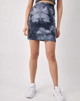 a close up cropped image of Luiza Blue Ribbed Tie Dye Skirt with white trainers