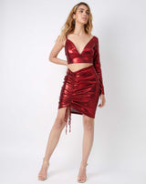 full length image of model with hand on hips wearing the kourt red ruched shiny skirt and matching top