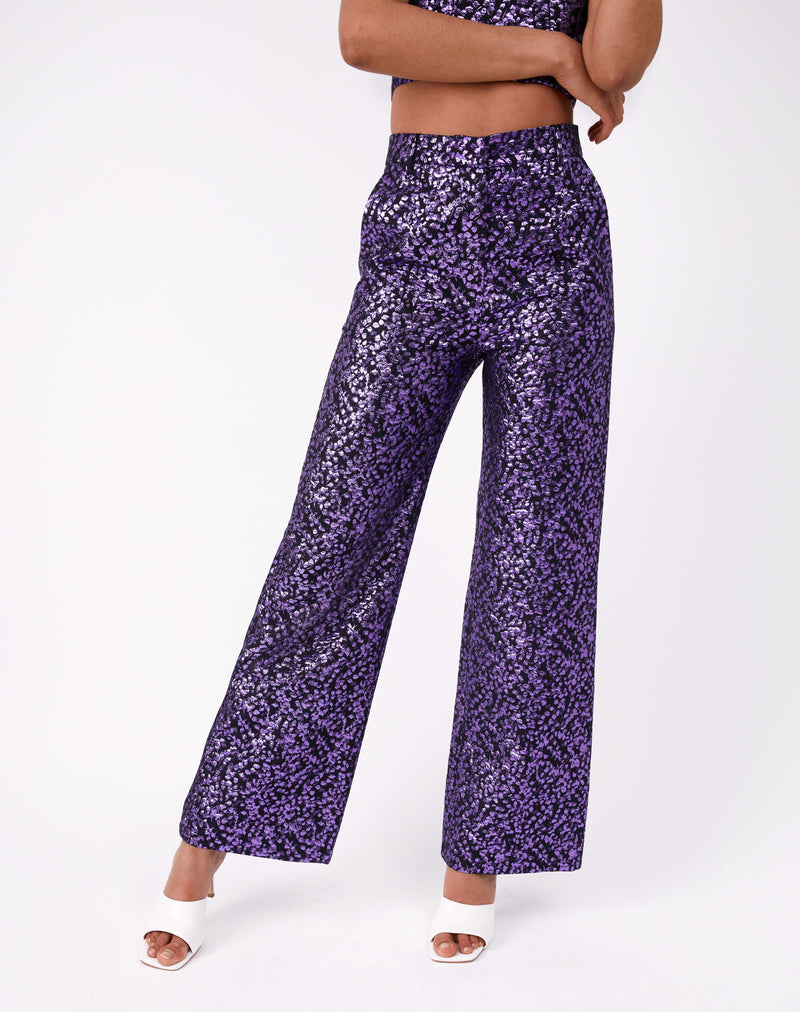 cropped image of model wearing the holly purple glitter wide leg jacquard trousers with white heels