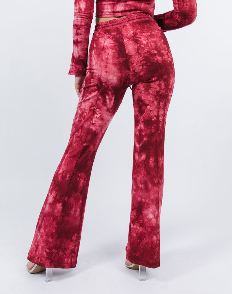 a cropped close image of the back of the Riley Red Tie Dye Flared Trousers with nude heels