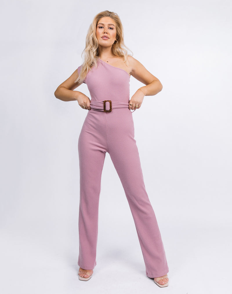 model has two hands on her hips while wearing the Laura One Shoulder Jumpsuit in Ribbed Blush