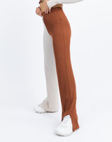 the model wears the Lana Wide Leg Trousers in Two Tone Rib from the side to show the slit in the leg
