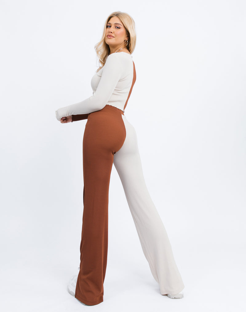 a shot of the model from the back wearing the Foxy Two Tone Ribbed Button Front Top with matching trousers