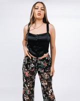 model had her hand in her pockets wearing the lisa black floral wide leg trousers
