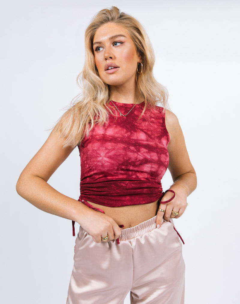 the model hold the waistband of her satin trousers wearing the Renee Tie Dye Ruched Sleeveless Top