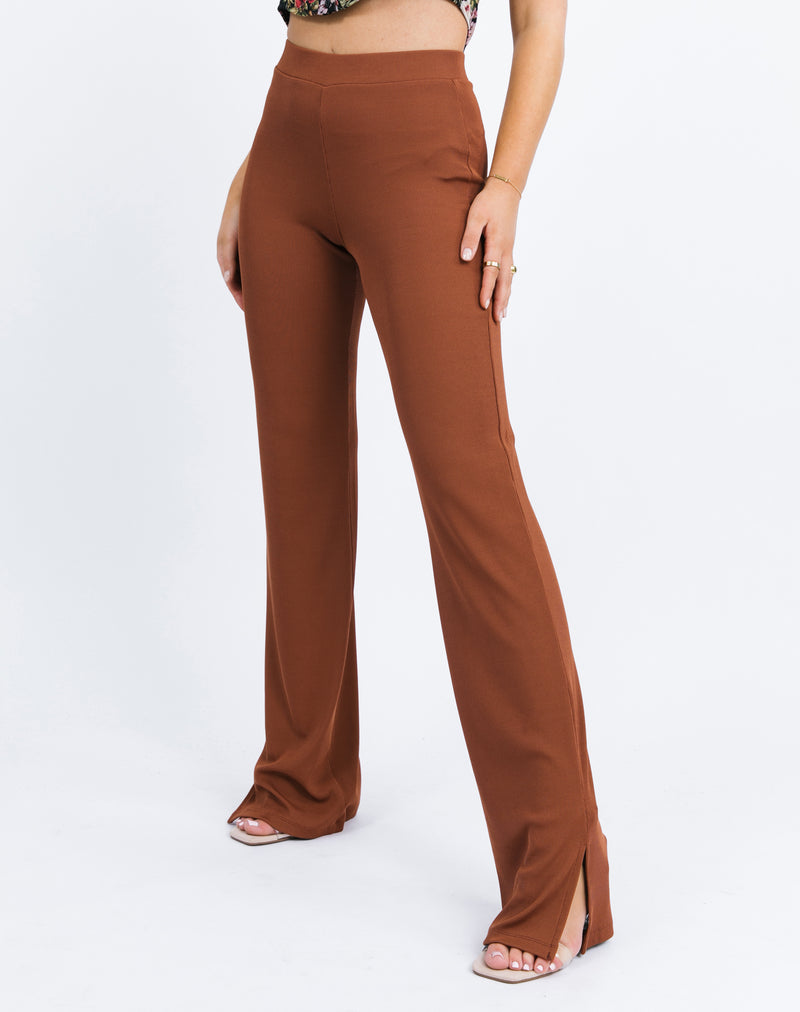 a sideways cropped close up of the model wearing the Lana Wide Leg Trousers in Chocolate Rib showing the side slit detail at hem.