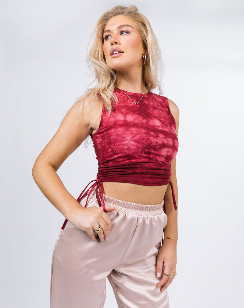 Model poses with the Renee Tie Dye Ruched Sleeveless Top paired with satin joggers
