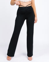 a close up cropped image of the florence ruched back trousers in black worn with nude heels