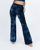 a cropped image of the model wearing the Riley Blue Tie Dye Flared Trousers