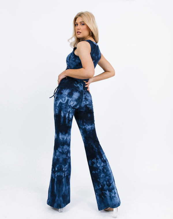 the model turns away from the camera in the Riley Blue Tie Dye Flared Trousers and matching top