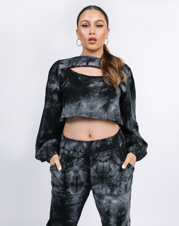 model wears the Threse Tie Dye Cut Out Long Sleeve Top with hands in pockets of matching trousers