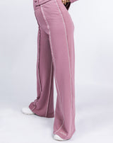 a sideways close up image of the model wearing Chantelle Contrast Stitch Logo Trousers in Blush