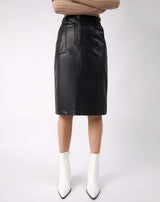 a cropped image of the Vita Black PU Midi Skirt With Pockets on a model with white boots