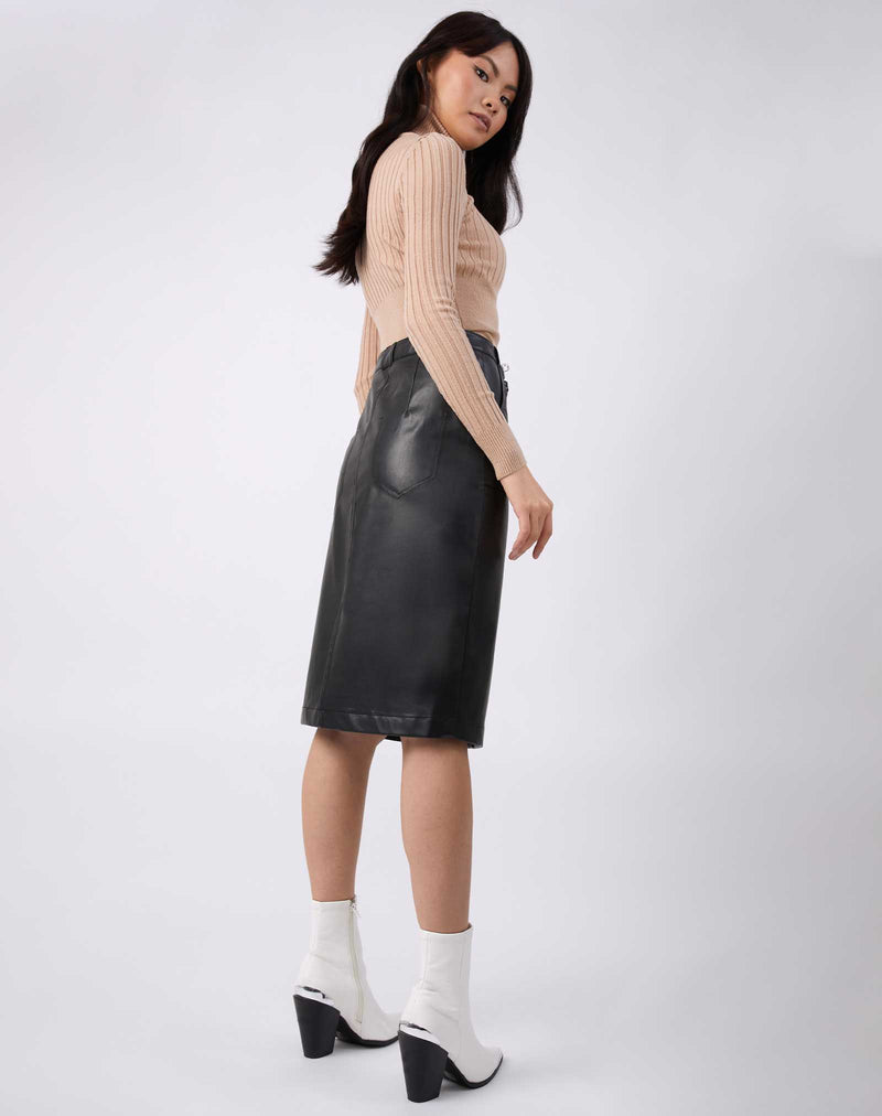 model looks over her shoulder wearing the Vita Black PU Midi Skirt With Pockets with matching ribbed jumper and white boots