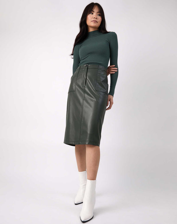 model wears Vita Green PU Midi Skirt With Pockets with ribbed green knit and white boots