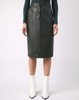 a close cropped image of the model wearing Vita Green PU Midi Skirt With Pockets with white boots