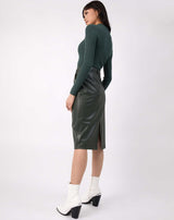 we see the back of the Vita Green PU Midi Skirt With Pockets on a model wearing green ribbed knit and white boots