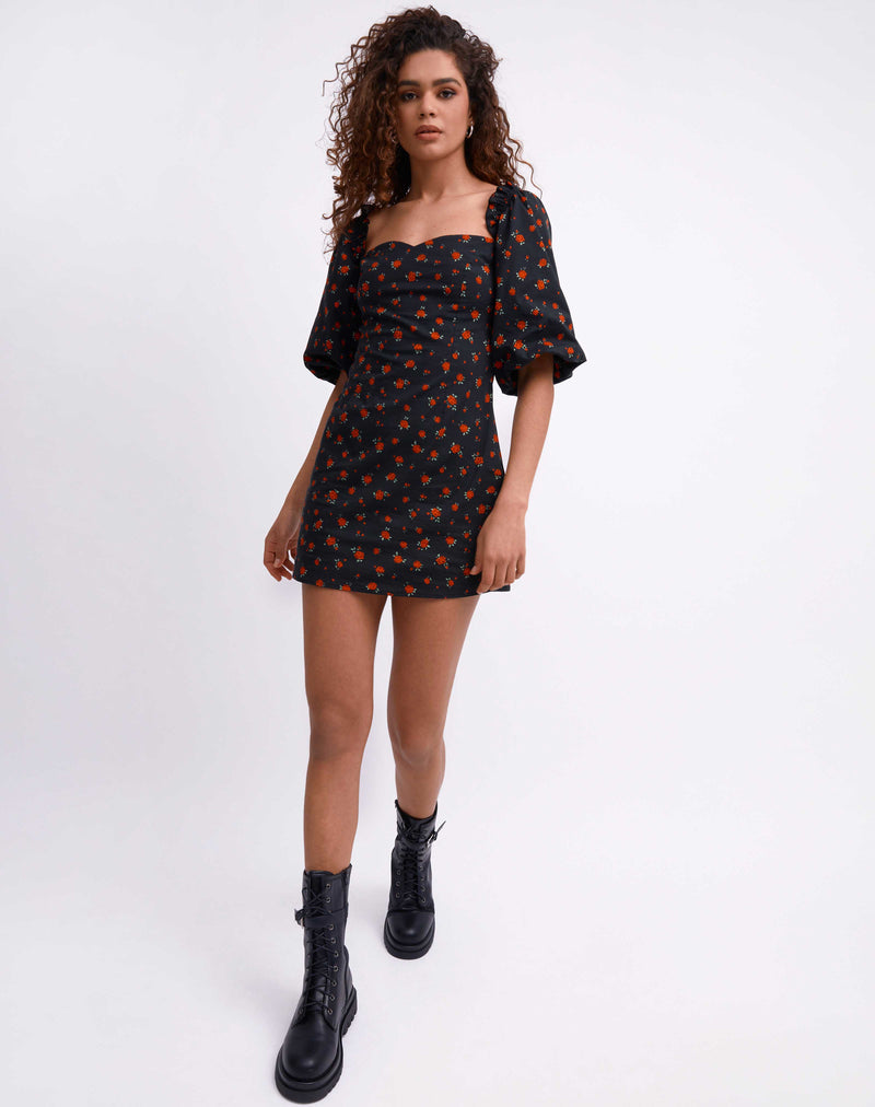 model wears the charlotte rose print puff sleeve mini dress while walking towards the camera in chunky boots